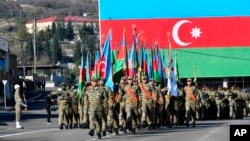 Azerbaijani troops march during a military parade in Khankendi, known by Armenians as Stepanakert, in Nagorno-Karabakh, on November 8.