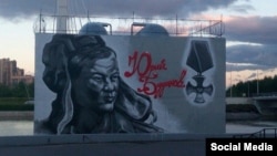 The graffiti portrait depicts the late Colonel Yury Budanov in a military uniform with his name written in blood-red letters.