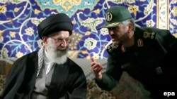 Iran's Supreme Leader Ayatollah Ali Khamenei (left) listens to Revolutionary Guards Commander Mohamad Ali Jafari during a ceremony in Tehran last month. Both Khamenei and the Revolutionary Guards are among those with the most to lose if the current system unravels in Iran.