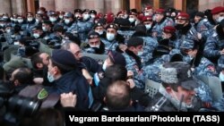 Armenian police officers clash with demonstrators in Yerevan on January 28.