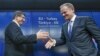 Turkish Prime Minister Ahmet Davutoglu (left) shakes hands with European Council President Donald Tusk after meeting to discuss Europe's migrant crisis. Turkey's neighbors fear that, if Ankara toughens its visa regime to help stem the flow of migrants into Europe, it could also drastically reduce the number of countries whose citizens can currently enter Turkey easily. 
