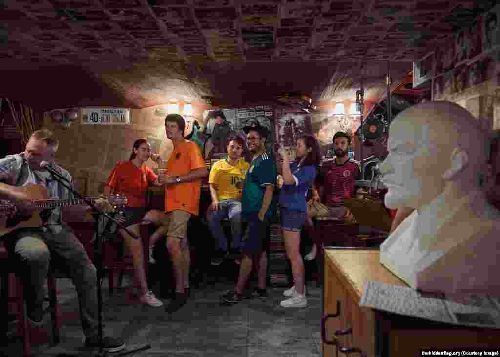 The group in a bar next to a bust of Lenin. Brazilian Eloi Pierozan Junior (in yellow) says his boyfriend warned him of the danger of protesting gay rights in Russia, but says “I’m not worried about the risk, it’s a project that I really want to be involved in.... It’s a call to love.”