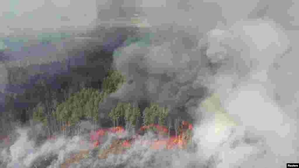 An aerial view shows a forest fire in the exclusion zone around the Chernobyl nuclear power plant on April 12. Ukraine's National Police said they had detained two people suspected of setting the initial fire.