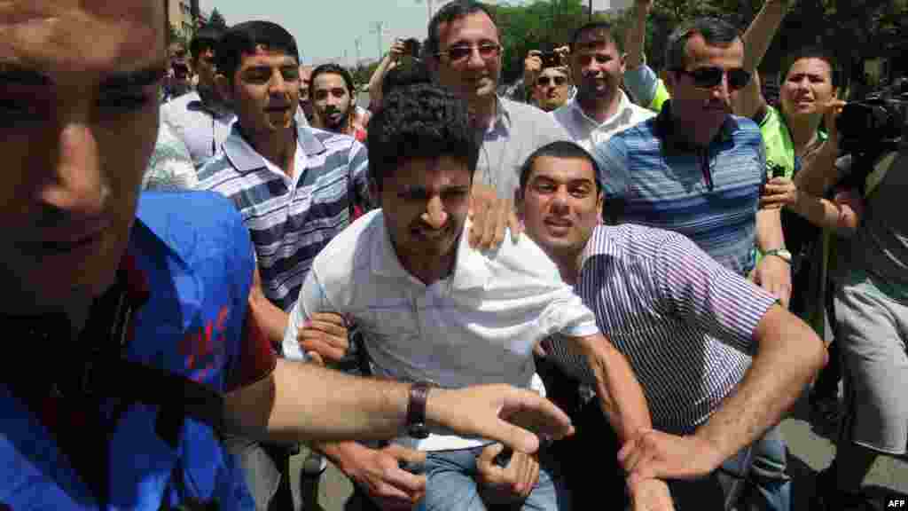 Activists attempted to use Baku's 2012 stint as Eurovision host as an opportunity to call attention to the regime's dismal rights record. Here, plainclothes police officers detain protesters outside Azerbaijan's public television station during the week of the Eurovision broadcasts. 