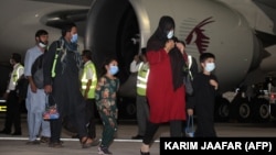 Evacuees from Afghanistan arrive at Hamad International Airport in Qatar's capital, Doha.