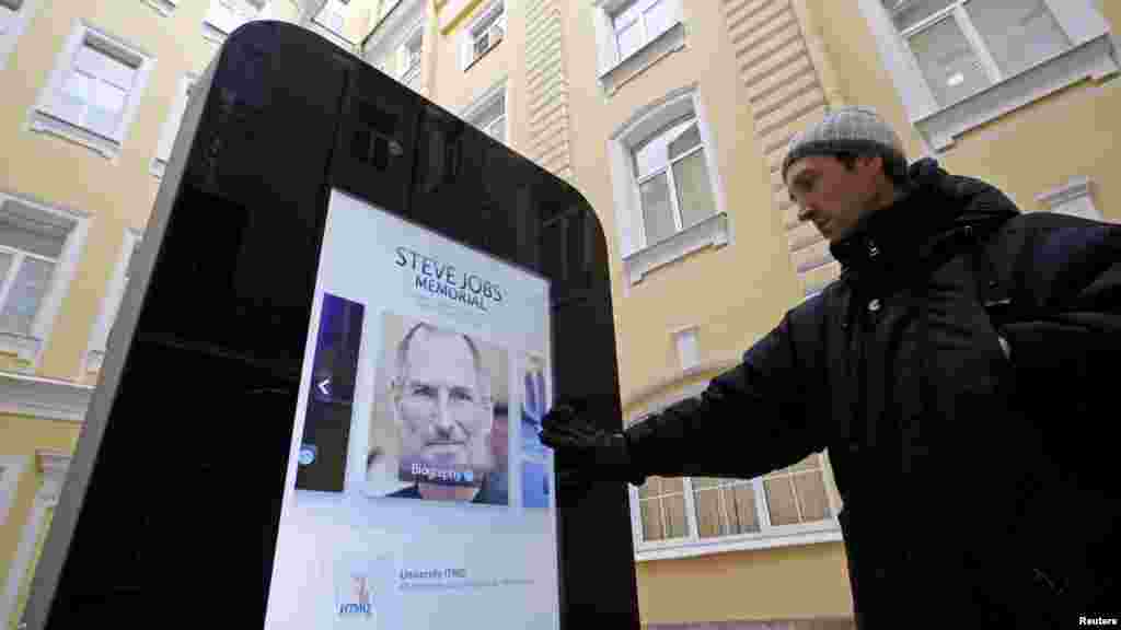 The screen displays video, photos and text documenting Jobs&#39; life.