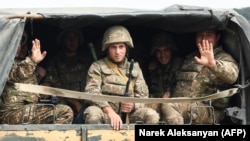 Ethnic Armenian Karabakh troops in the back of a truck on the way to the town of Martakert, Nagorno-Karabakh, in the midst of clashes with Azerbaijan on September 29.