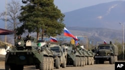 Russian peacekeepers' vehicles are parked at a checkpoint on the road to Shushi in Nagorno-Karabakh, November 17, 2020.