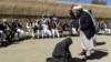An Afghan judge hits a woman with a whip in front of a crowd in Ghor Province. (file photo)