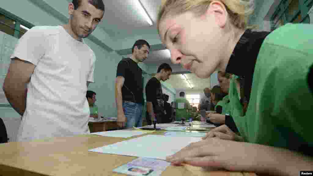 Inmates wait before receiving their ballots at a polling station in Tbilisi's Gldani Prison No. 8.