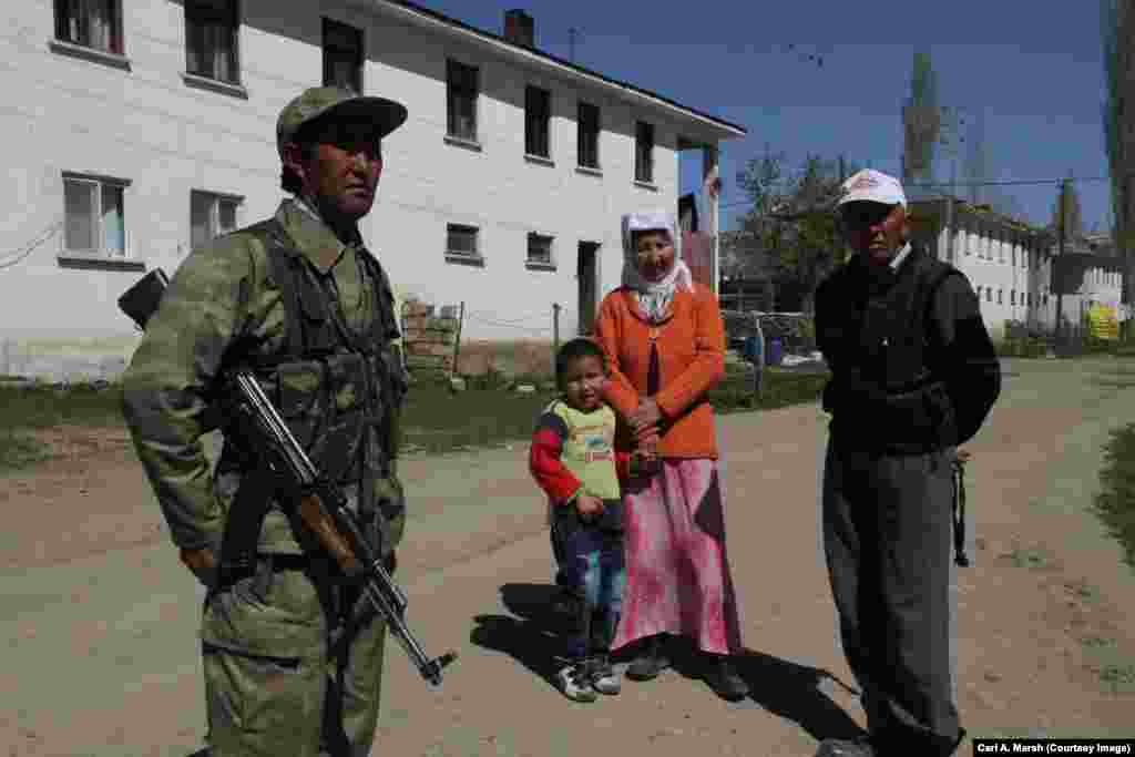 Mekhmet Turdu, a member of a local militia, with villagers. The Turkish government pays militia members to protect the Kyrgyz village from possible attacks by Kurdish militants who live in the region.
