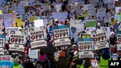 Demonstranți în fața Capitoliului de Stat din Minnesota în timpul protestului național „Hands Off!” împotriva președintelui american Donald Trump și a consilierului său, CEO-ul Tesla - Elon Musk, în St. Paul, Minnesota, pe 5 aprilie 2025.