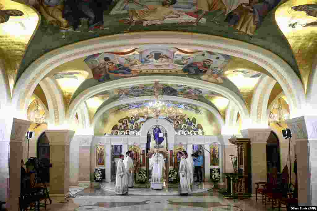 Serbian priests hold a morning Easter liturgy in the crypt of the cavernous St. Sava Temple, one of the world’s largest Orthodox houses of worship, in Belgrade on April 19. Most parishioners stayed away in an effort to limit the spread of the coronavirus. In Serbia, Montenegro, and Northern Macedonia, Easter holidays were celebrated at home, without the possibility of believers attending church services.