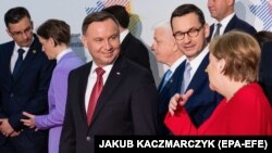 Polish President Andrzej Duda (left), Polish Prime Minister Mateusz Morawiecki (center), and German Chancellor Angela Merkel meet at the Western Balkans summit in Poznan.