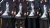 Protesters hold portraits of former President Burhanuddin Rabbani during a demonstration in Kabul on September 27.