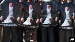 Protesters hold portraits of former President Burhanuddin Rabbani during a demonstration in Kabul on September 27.