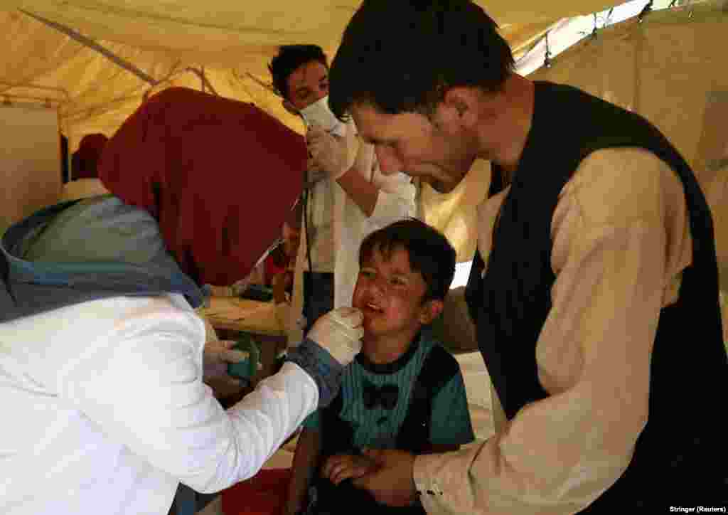 An Afghan child receives medical treatment in a Kabul park.