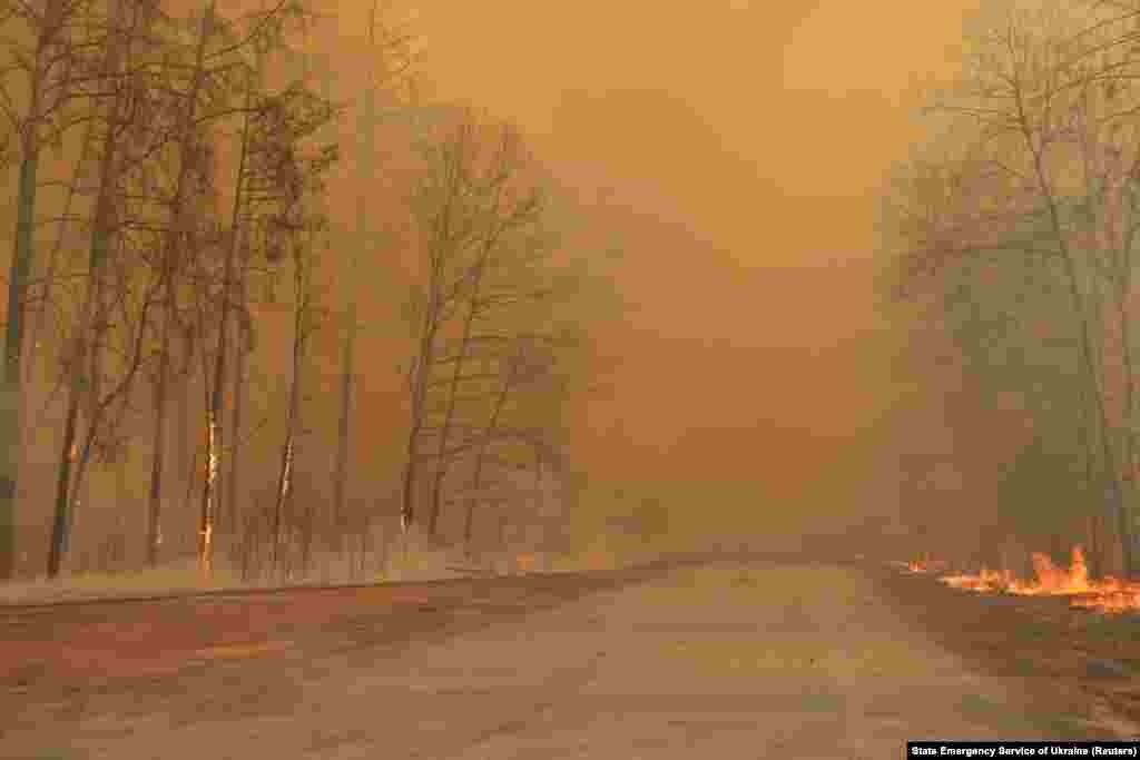 Smoke and flames gave the forest in the exclusion zone an eerie orange glow on April 10. Officials with Ukraine's Emergency Situations Service said that radiation in the region and in the capital, Kyiv, was within "permissible" levels.