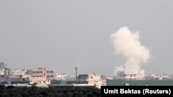 Smoke rises after an air strike in Saraqeb in Idlib Province on February 28.