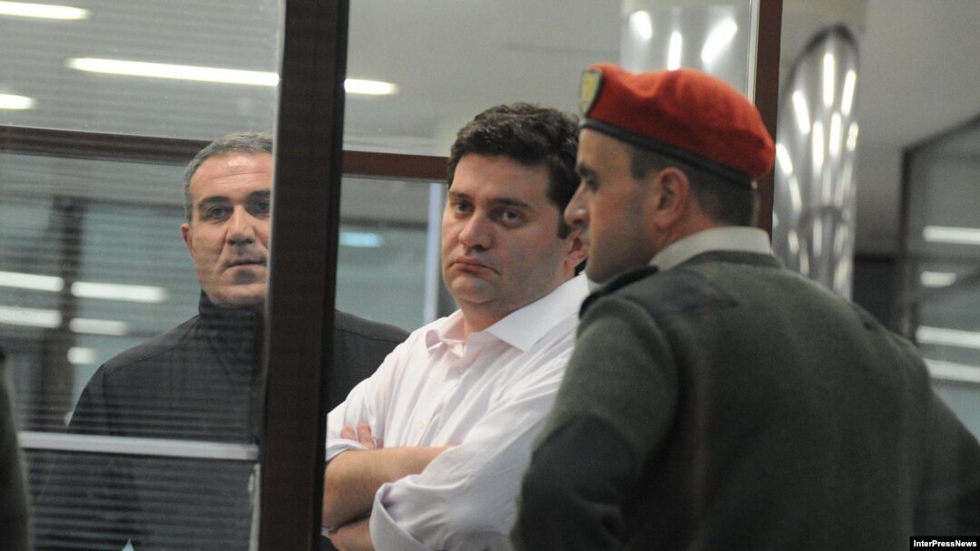 The arrest of Georgia's former Defense Minister Bacho Akhalaia (center) has given rise to speculation that a campaign is being waged against Prime Minister Bidzina Ivanishvili's political adversaries. 