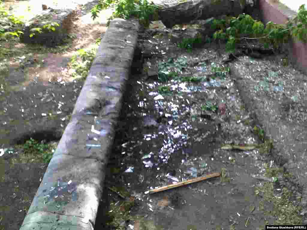 Shattered glass and blood on the ground at the scene of the explosion outside the detention facility in Astana on May 24, when two men are thought to have died.