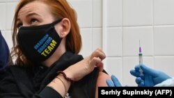 Anna Ilina, a member of the Ukrainian Olympic shooting team for the Tokyo 2020 Olympics, receives a dose of China's Sinovac vaccine in Kyiv on April 15.