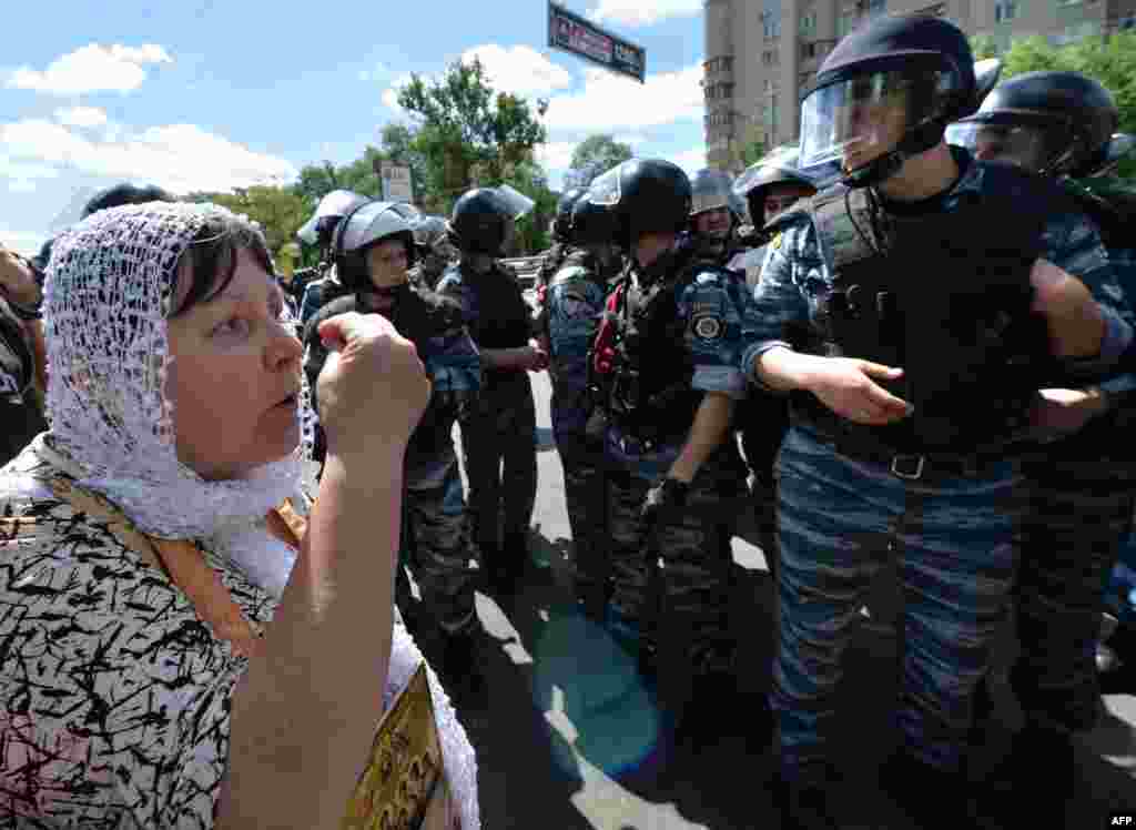 An Orthodox adherent remonstrates with police as she and others protest against the gay-rights march. 