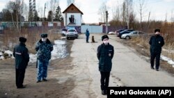 Police officers wearing face masks to protect against the coronavirus guard an entrance to Correctional Colony No. 2 in Pokrov on April 6.
