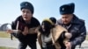 KYRGYZSTAN -- Kyrgyz police arrest a woman protesting against gender-based violence to mark International Women's Day in Bishkek, March 8, 2020.
