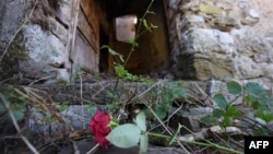 Cvijeće na ulazu u zapaljenu kuću u Gruborima, zaseoku pored Plavnog, oko 20 kilometara udaljenom od Knina, gdje je 25. kolovoza 1995. ubijeno petero starijih mještana srpske nacionalnosti