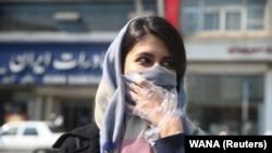 An Iranian woman in Iran covers her face amid a coronavirus outbreak in the Middle Eastern Country.