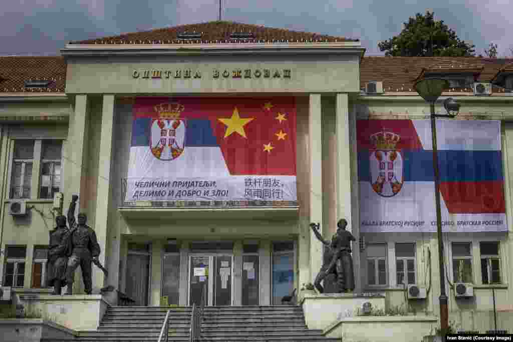 A banner linking Serbian and Chinese flags, and Serbian and Russian ones, on a municipal building in southern Belgrade on April 13. The Cyrillic script on the left says: “Iron Friends, Together In Good And Evil!" and on the right: “Thank You Brother Russia!” 