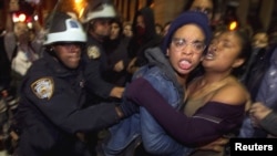 Members of the Occupy Wall Street movement clash with police officers after being removed from Zuccotti Park in New York in November. 
