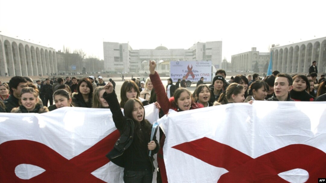 Kyrgyz university students hold banners with red ribbons, symbolizing AIDS awareness, in Bishkek. UN studies reveal that 70 percent of young people in Kyrgyzstan have little or no knowledge of HIV. 