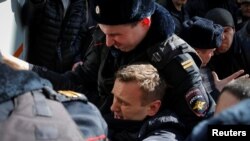 Police detaining Navalny on March 26 in Moscow.