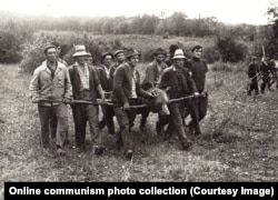 Men carry a bear carcass in from the forest for Ceausescu’s inspection during a hunting trip in 1972.