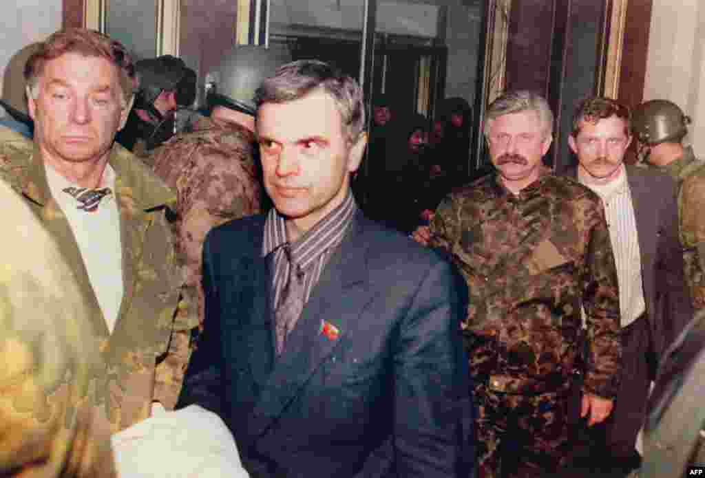 Former parliament chairman Ruslan Khasbulatov (second from left) and former Vice President Aleksandr Rutskoi (third from right) being escorted from the parliament building on October 4. 