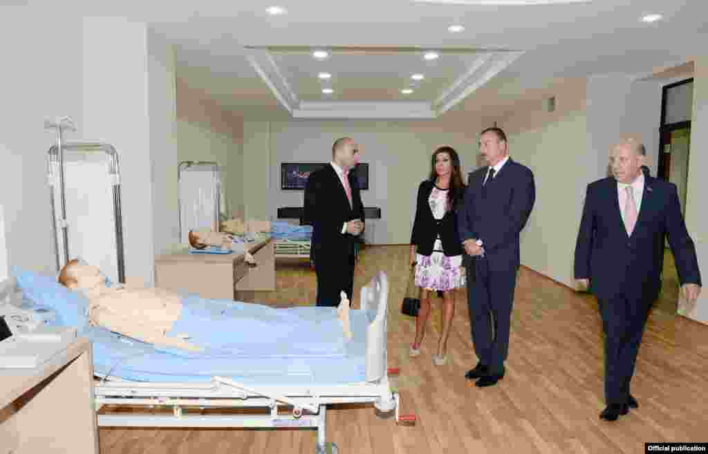 Aliyev's public appearances have been largely limited to ribbon-cutting ceremonies at public buildings, many of which have undergone recent renovations paid for by the presidential reserve fund. Aliyev and his wife visit the opening of a new hospital in Baku on September 12 -- with mannequins standing in as makeshift patients.