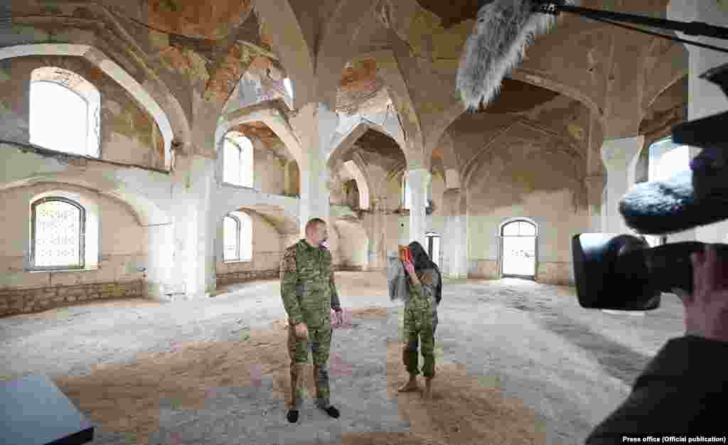 Azerbaijani President Ilham Aliyev and his wife -- who is also the country's vice president -- pose with a Koran inside the main mosque on November 22. Lohr adds that he is "of course worried because it's not easy to overcome all these emotions connected to the war" with "so many injustices happening there."