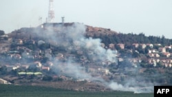 A photo taken from southern Lebanon shows smoke billowing in the northern Israeli town of Metulla from cross-border rockets launched from the Lebanese side on June 26.