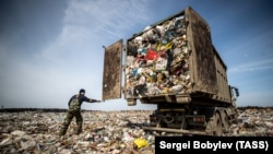 A truck dumps garbage at the Yadrovo site outside Moscow.