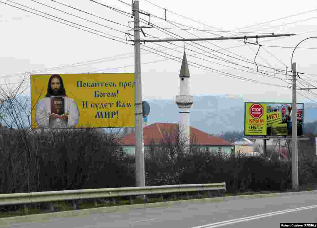 A Christian message, a mosque, and an anti-Maidan billboard ('No to foreign interference!') on the road from Simferopol to Yalta.