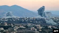 Smoke plumes erupt after an Israeli air strike targeted the village of Khiam in southern Lebanon near the border with northern Israel on September 30.