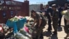 Люди несут цветы к портретам военнослужащих, убитых при атаке на воинскую часть 6655 в Актобе. 9 июня 2016 года.