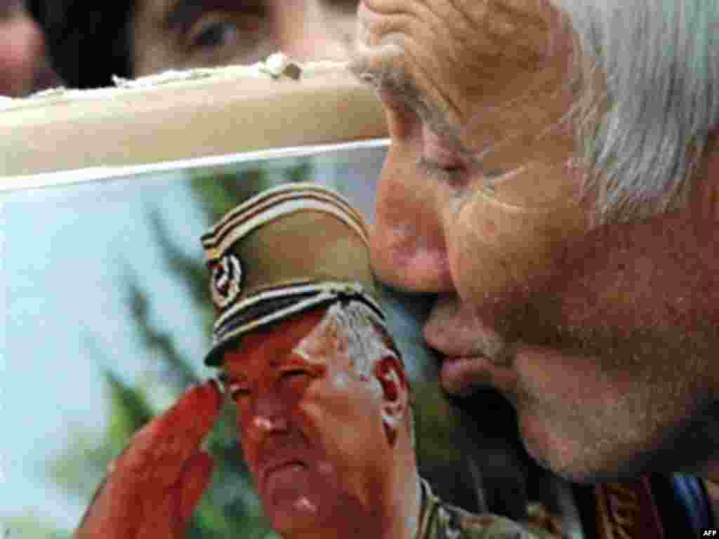 A supporter of the ultra-nationalist Serbian Radical Party kisses a picture of Mladic in Belgrade on May 6, 2008.