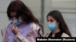 Krestina (left) and Angelina Khachaturyan, two of the three sisters accused of killing their father, arrive for a court hearing in Moscow in July. 