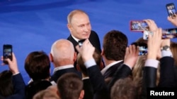 Russian President Vladimir Putin attends a forum of the All-Russia Popular Front in Moscow on December 19.