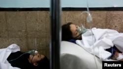Schoolgirls who fell ill after reportedly smelling gas at their school, receive treatment at a hospital in Kabul on May 1.