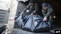 Ukrainian soldiers unload the bodies of their comrades killed in Debaltseve at a checkpoint near Horlivka on February 24.