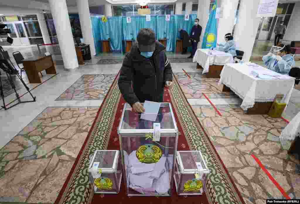 A voter wearing a protective mask votes during parliamentary and local elections in Kazakhstan&#39;s largest city, Almaty, on January 10.